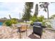 Outdoor patio area with a grill and table, ideal for barbecues and enjoying the outdoors with friends and Gathering at 1731 Redwood St, Sarasota, FL 34231