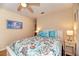 Charming bedroom with light yellow walls, wood floors, ceiling fan and two windows, plus coastal decor at 1731 Redwood St, Sarasota, FL 34231