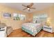 Bedroom with light yellow walls, wood floors, ceiling fan and two windows at 1731 Redwood St, Sarasota, FL 34231