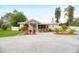 Charming single-story home featuring a well-maintained yard with gravel driveway and colorful plants at 1731 Redwood St, Sarasota, FL 34231