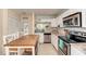 Bright kitchen features stainless appliances, granite counters, tile backsplash, and a center island with seating at 1731 Redwood St, Sarasota, FL 34231