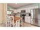 Bright kitchen features stainless appliances, granite counters, tile backsplash, and a center island with seating at 1731 Redwood St, Sarasota, FL 34231