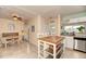 Open kitchen and dining area with an island, white cabinets, and access to the outside patio at 1731 Redwood St, Sarasota, FL 34231