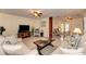 Spacious living room with neutral walls, tile floors, ceiling fan, and access to a dining area at 1731 Redwood St, Sarasota, FL 34231