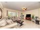 Open-concept living room with tile flooring, neutral paint, comfortable seating, and natural light at 1731 Redwood St, Sarasota, FL 34231