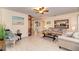Bright living room with neutral paint, ceiling fan, tile floors, and comfortable seating arrangement at 1731 Redwood St, Sarasota, FL 34231