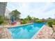 Sparkling pool surrounded by lush landscaping, offering a private oasis for swimming and recreation at 1731 Redwood St, Sarasota, FL 34231