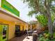 Inviting restaurant patio with ample seating, mature trees, and umbrellas at 1731 Redwood St, Sarasota, FL 34231