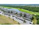Scenic aerial view of condo community showcasing lush landscaping, a pristine lake, and a well-manicured golf course at 17510 Gawthrop Dr # 206, Bradenton, FL 34211