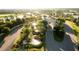 Stunning aerial view of a community entrance with lush landscaping, water features, and a grand gateway at 17510 Gawthrop Dr # 206, Bradenton, FL 34211