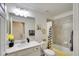 Bathroom features a marble vanity, a large mirror, and a shower/tub combination with yellow accents at 17510 Gawthrop Dr # 206, Bradenton, FL 34211