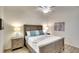 Neutral bedroom features a wooden bed frame with soft blue accents and matching bedside lamps at 17510 Gawthrop Dr # 206, Bradenton, FL 34211