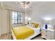 Bedroom features a white bed frame with yellow accents, complemented by matching bedside tables and lamps at 17510 Gawthrop Dr # 206, Bradenton, FL 34211