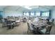 Open-concept dining room with neatly arranged tables, chairs, and soft lighting fixtures at 17510 Gawthrop Dr # 206, Bradenton, FL 34211