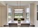 Dining area with a gray table and chairs, complemented by a modern chandelier and golf course views at 17510 Gawthrop Dr # 206, Bradenton, FL 34211