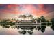 Lakewood National entrance with serene lake and a dramatic sunset sky backdrop, reflecting in the water at 17510 Gawthrop Dr # 206, Bradenton, FL 34211