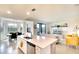 Bright and open kitchen with white cabinets, stainless steel appliances, and view of the dining and living area at 17510 Gawthrop Dr # 206, Bradenton, FL 34211