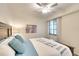 Neutral bedroom features a wooden bed frame with soft blue accents and a large window at 17510 Gawthrop Dr # 206, Bradenton, FL 34211