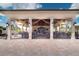 Outdoor bar and dining area with covered seating, TVs, and ample space for entertaining at 17510 Gawthrop Dr # 206, Bradenton, FL 34211