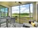 Screened patio with outdoor seating offering scenic views of the golf course and lush greenery at 17510 Gawthrop Dr # 206, Bradenton, FL 34211