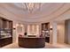 Inviting reception area with an elegant chandelier, decorative display shelves, and a curved desk at 17510 Gawthrop Dr # 206, Bradenton, FL 34211