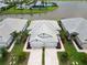 Aerial view of the property with well-manicured lawn, decorative landscaping, and community pool in the background at 17885 Cherished Loop, Bradenton, FL 34211