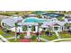 Stunning aerial view of community pool, clubhouse, tennis and play areas with lush landscaping at 17885 Cherished Loop, Bradenton, FL 34211