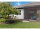 Well-maintained backyard with tropical tree, lush grass, and screened patio at 17885 Cherished Loop, Bradenton, FL 34211