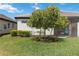 Landscaped backyard featuring lush lawn and patio with a screen enclosure at 17885 Cherished Loop, Bradenton, FL 34211