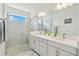 Bright bathroom features a glass shower and double sink at 17885 Cherished Loop, Bradenton, FL 34211