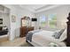 This primary bedroom is bright with natural light and features dark wood furniture at 17885 Cherished Loop, Bradenton, FL 34211