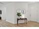 Entryway with console table, mirrors, and warm wood flooring, offering a welcoming first impression at 17885 Cherished Loop, Bradenton, FL 34211