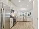 Bright, open kitchen with stainless appliances and view to living space creating an airy and connected feel at 17885 Cherished Loop, Bradenton, FL 34211