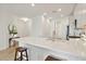 Spacious kitchen island featuring quartz countertops, a farmhouse sink, and space for seating at 17885 Cherished Loop, Bradenton, FL 34211