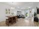 Open-concept living and dining area with modern furniture, decor, and backyard views at 17885 Cherished Loop, Bradenton, FL 34211