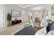 Living room with a leather sofa, ottoman, and view to the dining and kitchen area at 17885 Cherished Loop, Bradenton, FL 34211