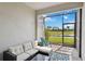 Relaxing screened patio with wicker sectional and view of the pond at 17885 Cherished Loop, Bradenton, FL 34211