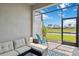 Inviting screened patio with comfortable seating and tranquil water view at 17885 Cherished Loop, Bradenton, FL 34211