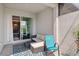 Cozy patio featuring wicker furniture, blue rug, and view into home at 17885 Cherished Loop, Bradenton, FL 34211