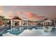 Tranquil community pool with lounge chairs and umbrellas for relaxation at 17885 Cherished Loop, Bradenton, FL 34211