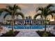 A serene community pool with palm trees and lounge seating creates a resort-like atmosphere at 17885 Cherished Loop, Bradenton, FL 34211
