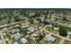 Aerial view of a residential neighborhood with single-story homes, green trees, and community lake at 1789 Elm Dr, Venice, FL 34293