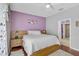 Cozy bedroom with hardwood floors, a comfortable bed, and an ensuite bathroom at 1789 Elm Dr, Venice, FL 34293