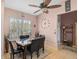 Cozy dining area features a table with seating, large windows for natural light, and a ceiling fan for added comfort at 1789 Elm Dr, Venice, FL 34293