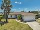 Charming single-story home boasts a well-manicured lawn and an attached two-car garage at 1789 Elm Dr, Venice, FL 34293