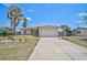An inviting single-Gathering home boasts a two-car garage and simple landscaping, complemented by a well-maintained front yard at 1789 Elm Dr, Venice, FL 34293