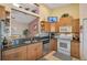 The kitchen features stainless steel appliances, granite countertops, and a view into the adjacent living area at 1789 Elm Dr, Venice, FL 34293