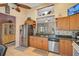 Modern kitchen featuring stainless steel appliances, granite countertops, tiled backsplash, and ample cabinet space at 1789 Elm Dr, Venice, FL 34293