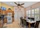 Bright kitchen and dining area with stainless steel appliances, tile flooring, and a breakfast table with seating at 1789 Elm Dr, Venice, FL 34293