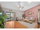 A bright living room with hardwood floors, comfortable couches, and access to an outdoor patio through sliding glass doors at 1789 Elm Dr, Venice, FL 34293